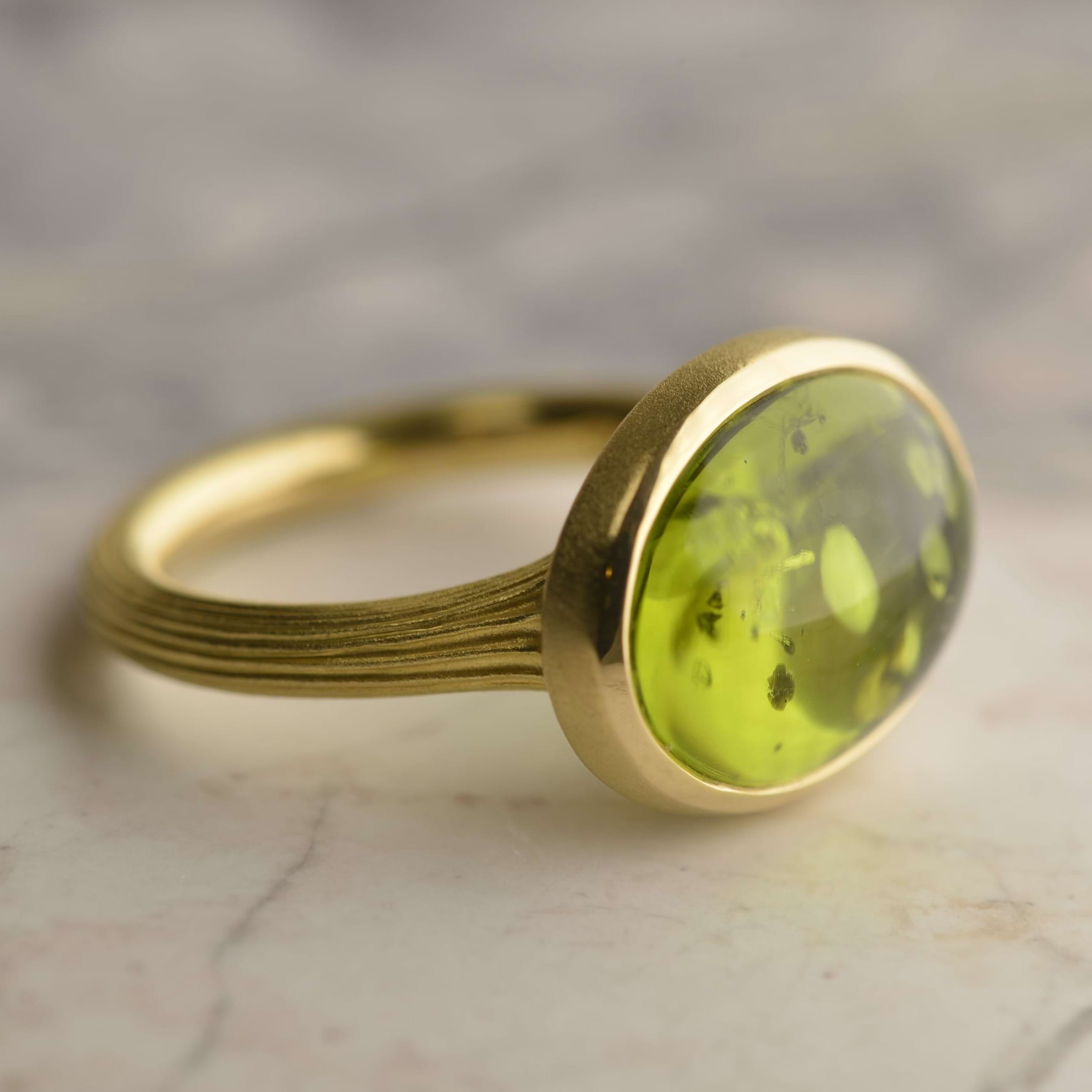 18ct yellow gold ring with a 9.5ct vivid green cabochon peridot and fluted band detail. Handmade by Sydney jeweller Nicky Burles.