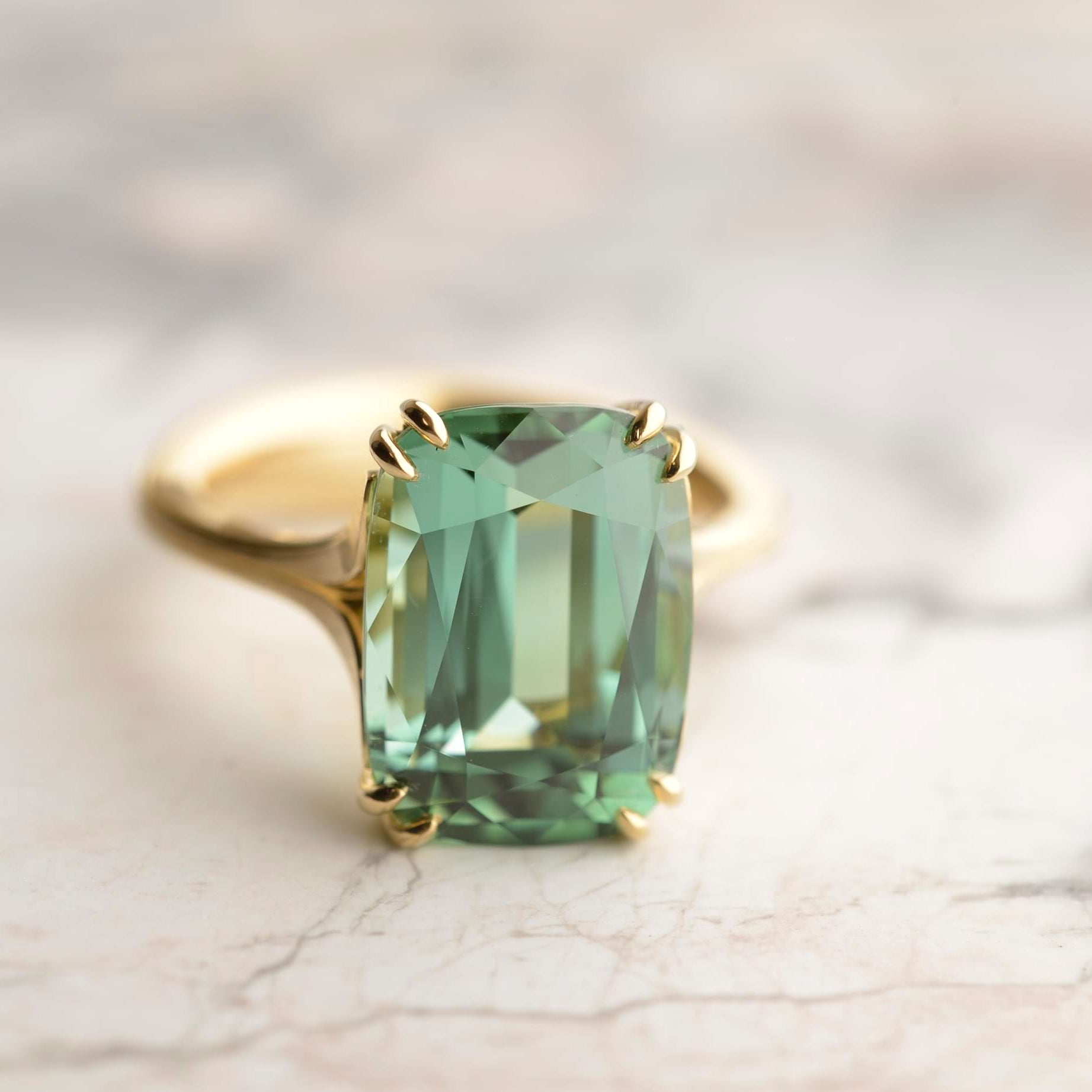 18ct yellow gold ring featuring a stunning 8.35-carat antique cushion cut Afghan tourmaline, set in double claws. Handmade by Sydney jeweller Nicky Burles.