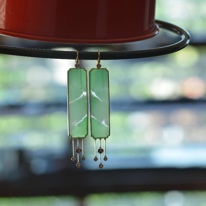 Hanging earrings featuring semi translucent Australian Chrysoprase with clear inclusions captured in the light.
Set in 18 ct gold and with pastel pink Ceylon sapphire tassel detail. Handmade by Sydney jeweller Nicky Burles.