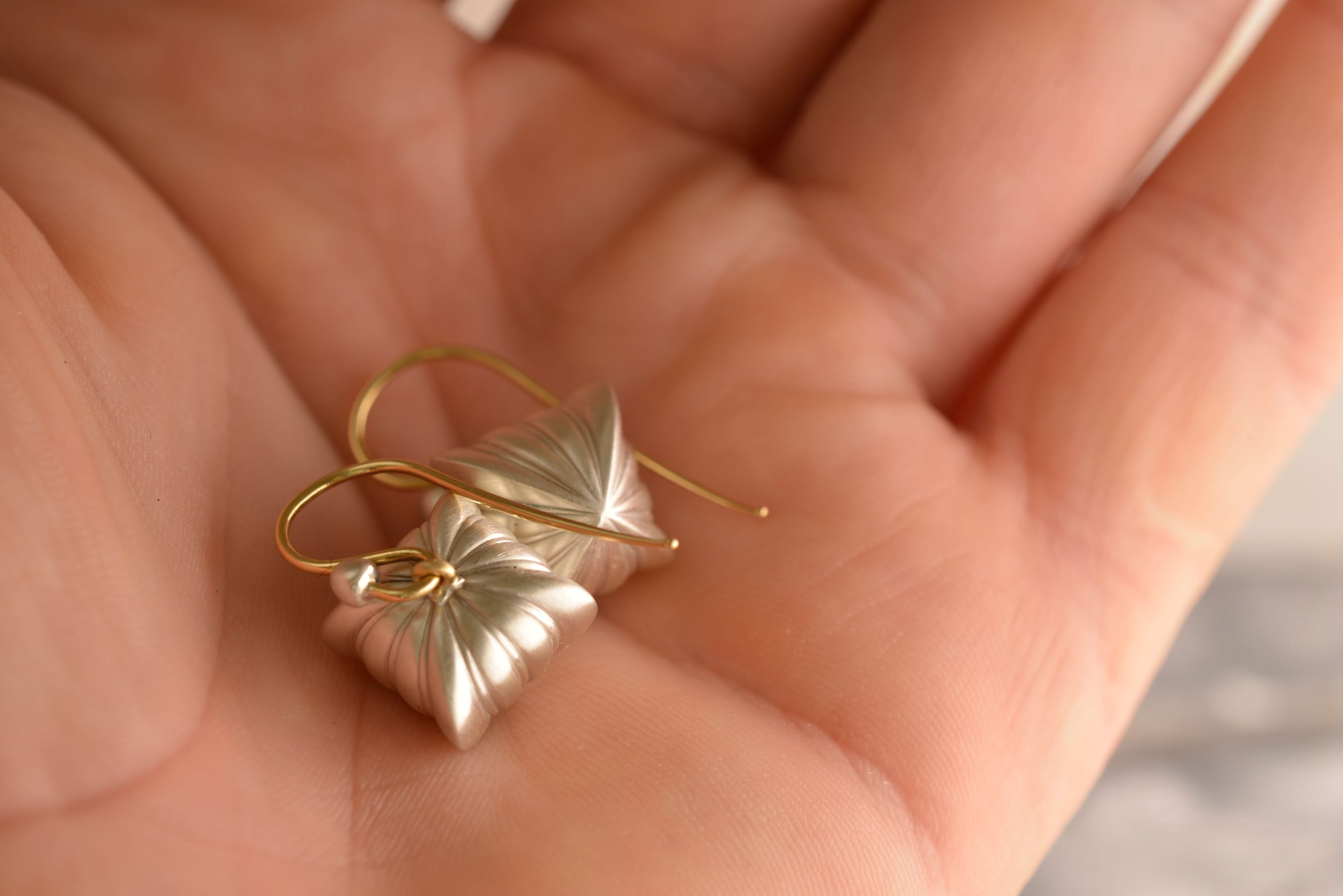 Vintage-style silver earrings shaped as Georgian hearts in Nicky's hand. Handcrafted by Sydney jeweller Nicky Burles.