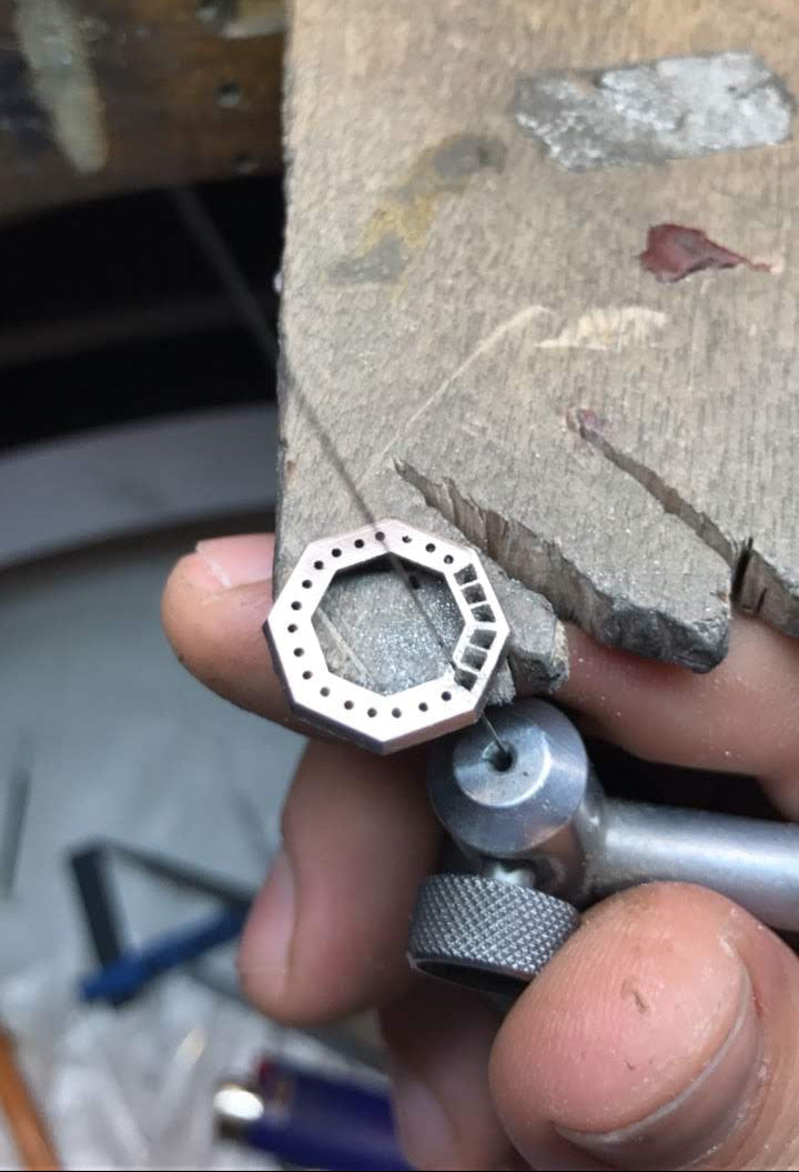 Sydney jeweller Nicky Burles handpiercing an octagon platinum halo for a custom spphire ring