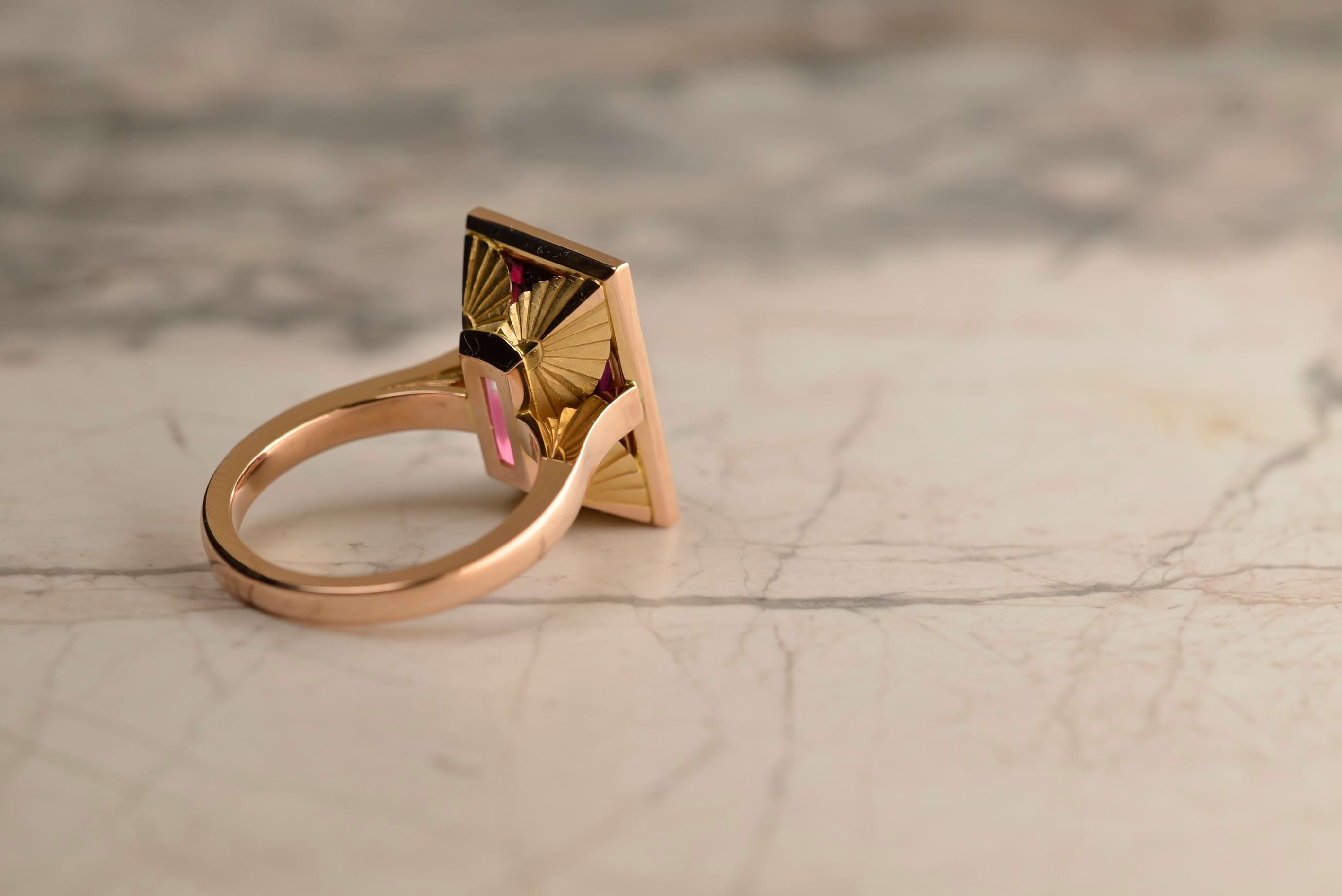 Back view of rhodolite garnet art deco dress ring featuring recurring geometric fan motif, created by deep-set hand engraving over a single plane. Handmade in 18ct rose gold by Sydney jeweller Nicky Burles.