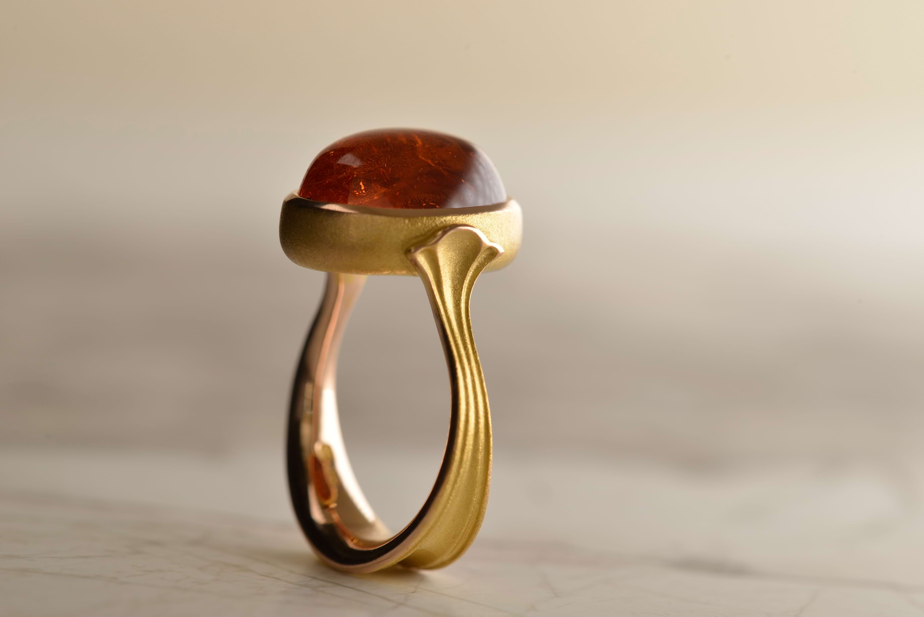 17-carat cabochon Mandarin Garnet set in 18-carat rose gold in the Nicky Burles signature lotus design.
