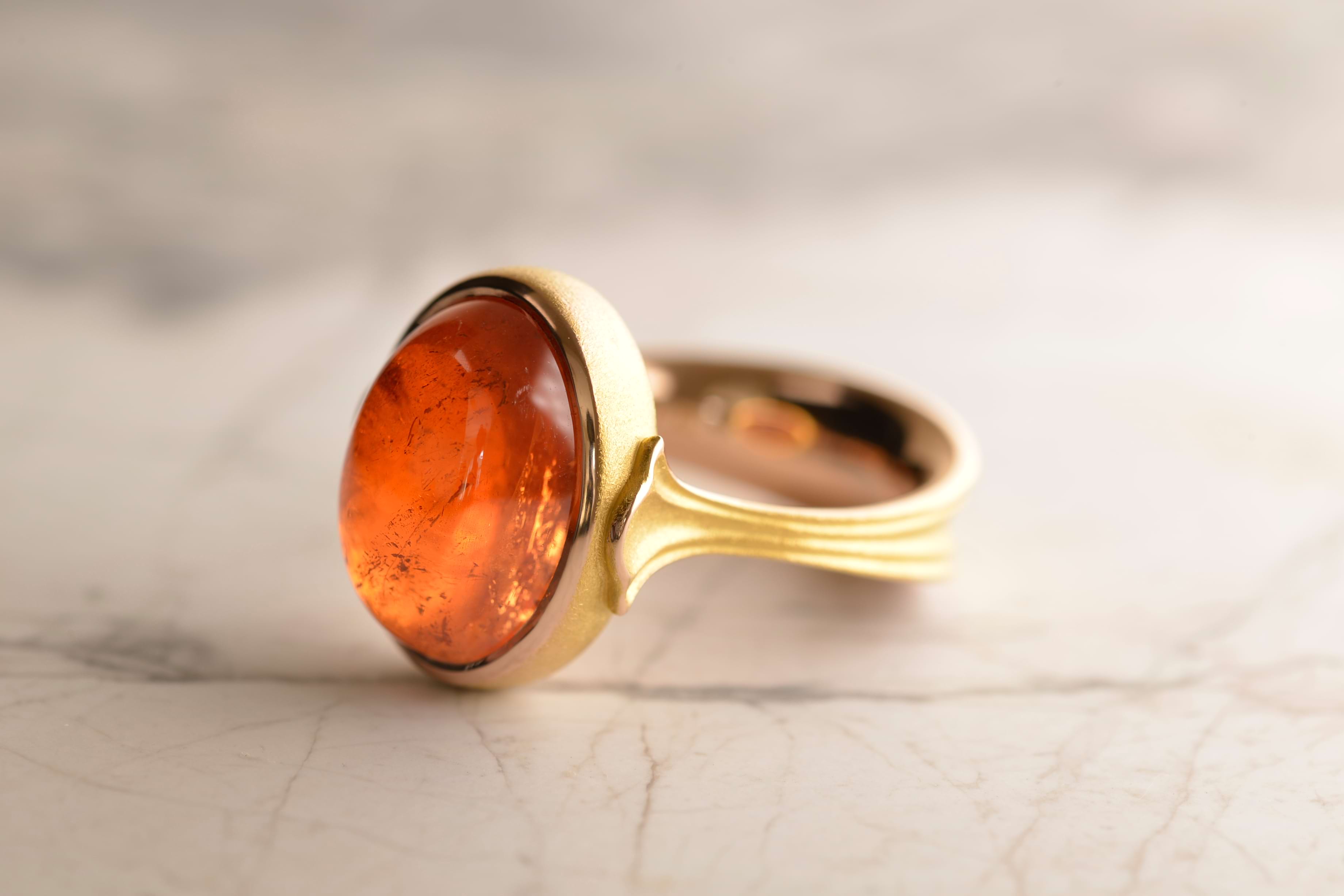 Signature lotus ring featuring 17-carat cabochon Mandarin Garnet set in 18-carat rose gold. Handcrafted by Sydney jeweller Nicky Burles.