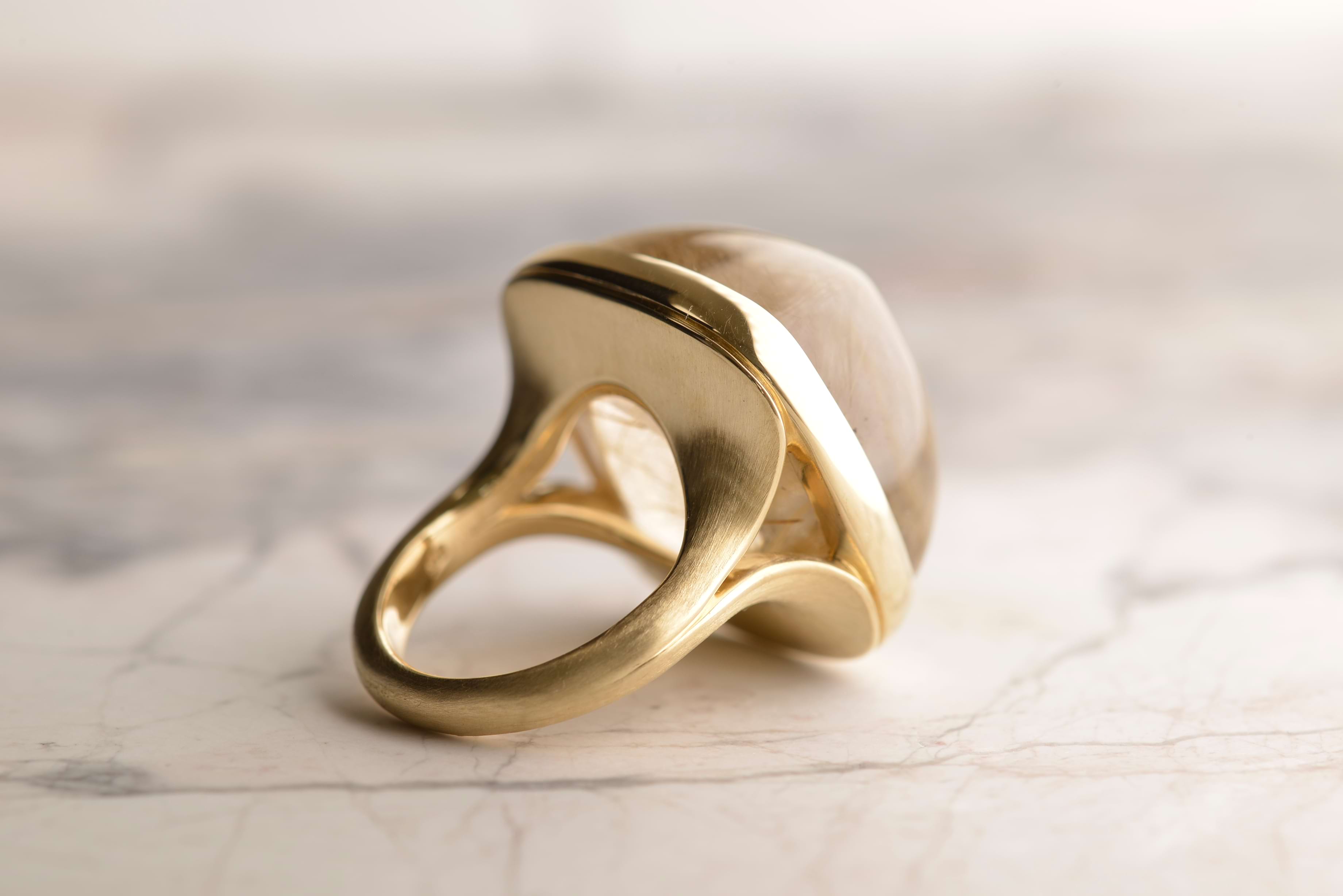 Back view of 9ct yellow gold ring featuring a 50-carat rutilated quartz with luminous titanium dioxide inclusions, set on a satin-finished shank. Handmade by Sydney jeweller Nicky Burles.