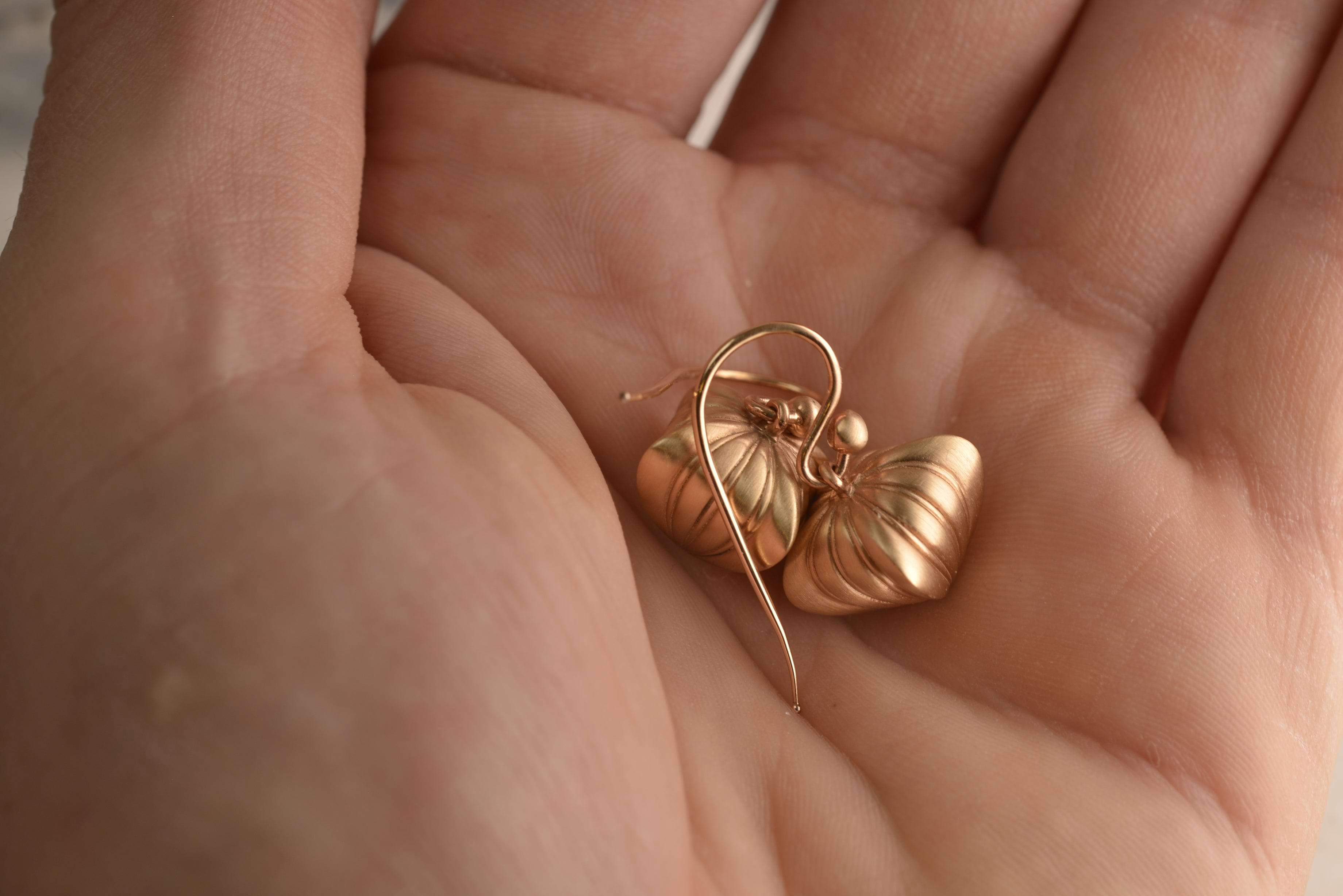 Romantic 9ct rose gold earrings crafted into Georgian heart silhouettes sitting in the palm of Nicky's hand. Handcrafted by Sydney jeweller Nicky Burles.