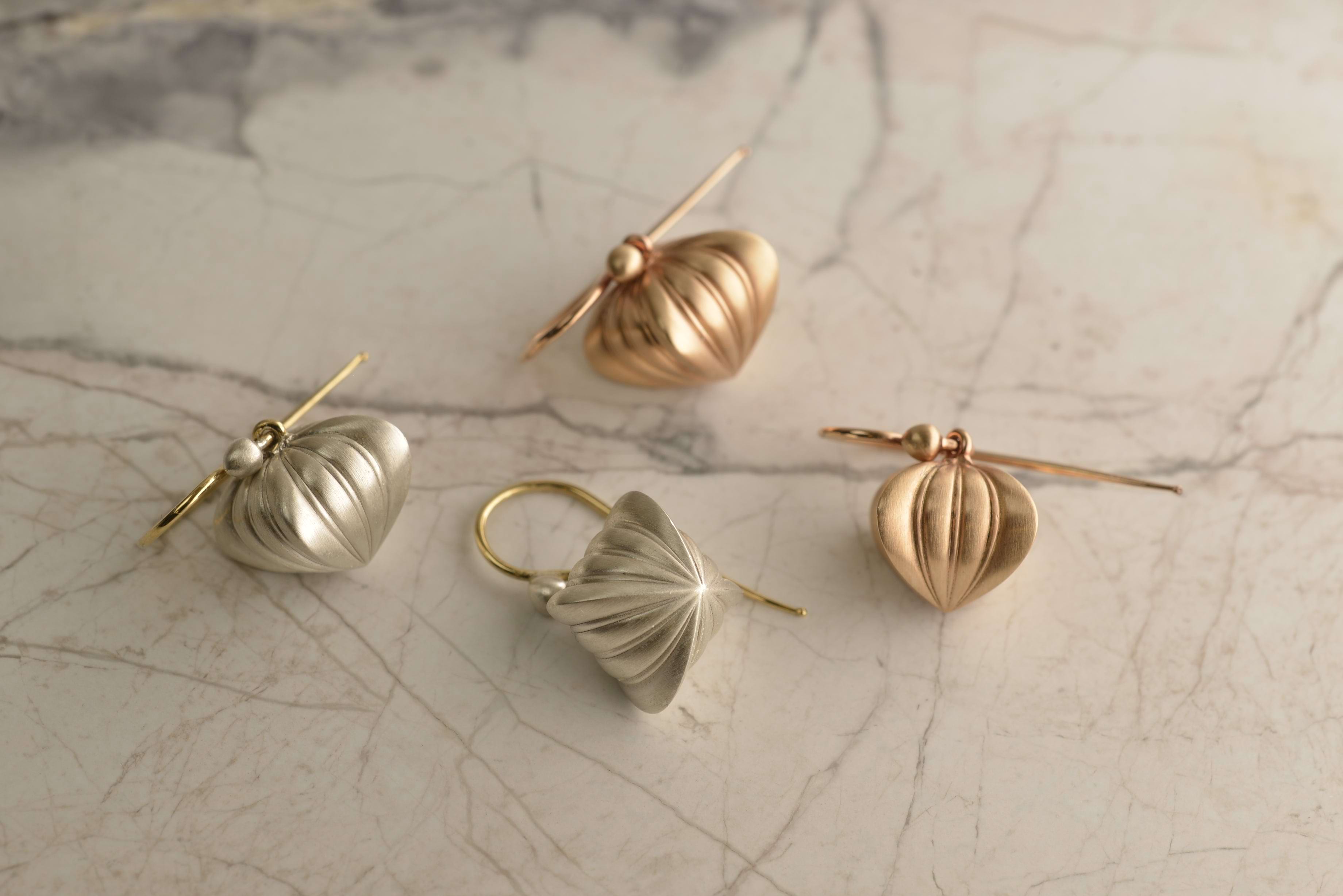 2 pairs of earrings n georgian heart silhouettes, one pair in rose gold and the other in silver. Handcrafted by Sydney jeweller Nicky Burles.