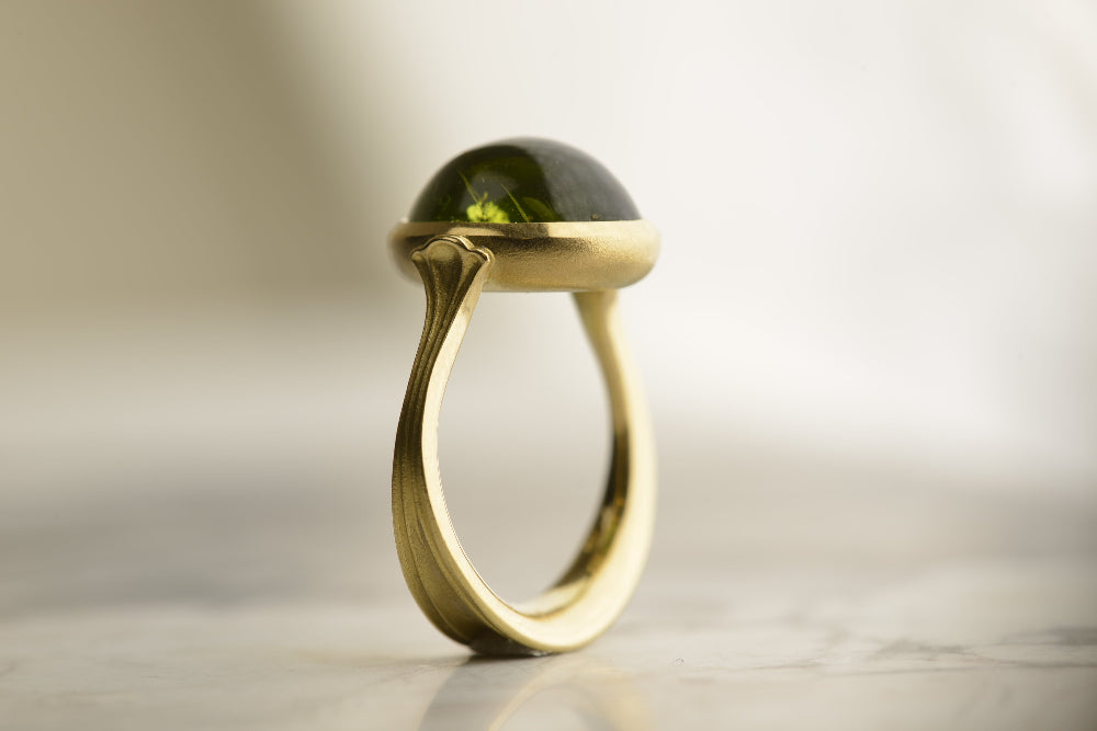  Standing view of signature Nicky Burles fluted Lotus ring featuring a 10-carat peridot set in 18-carat yellow gold.