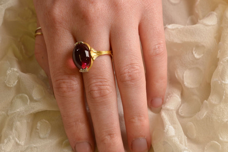 Wearing bespoke 18ct rose gold dress ring with a 16ct raspberry rubellite tourmaline cabochon and diamond fleur-de-lis accents set in milgrain details in platinum. Handmade by Sydney jeweller Nicky Burles.