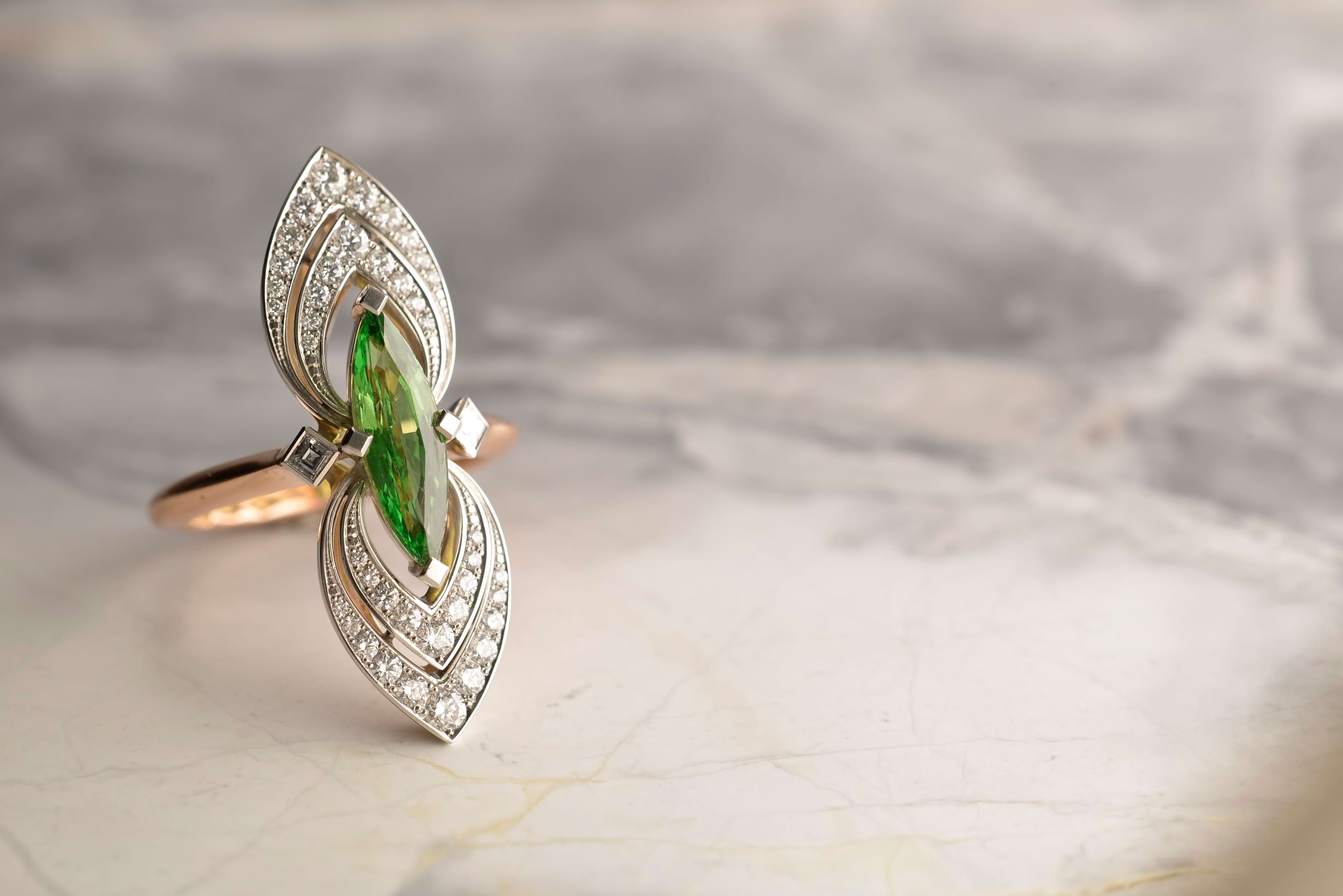 Bespoke platinum and rose gold ring with a 2.25ct marquise tsavorite garnet and round brilliant and carre cut diamonds. Handmade by Sydney jeweller Nicky Burles.