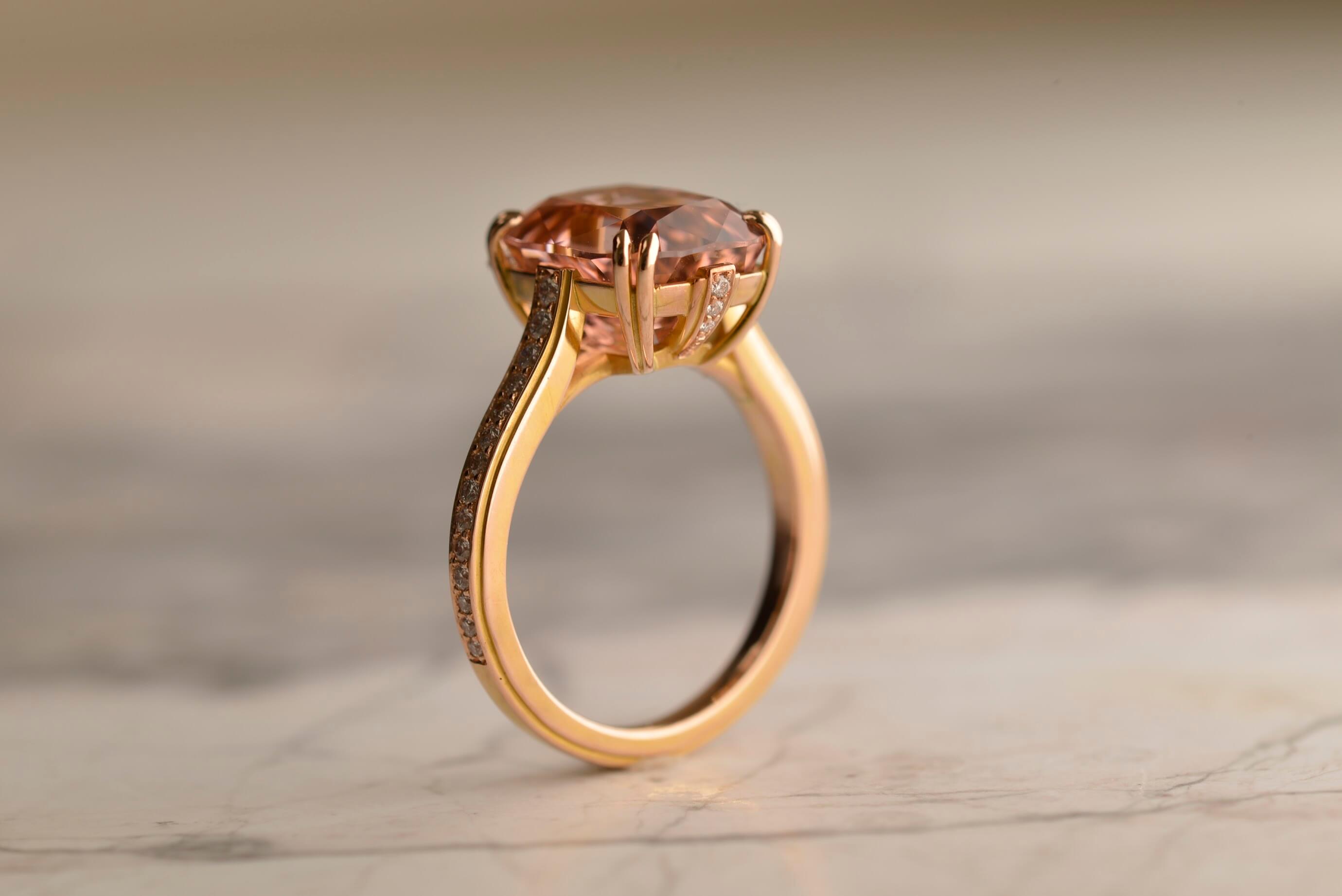 Side view of art deco inspired bespoke rose gold ring featuring a 5.56ct pink antique cushion cut Afghan tourmaline set in double claws and with 36 diamonds set on the band. Handmade by Sydney jeweller Nicky Burles.