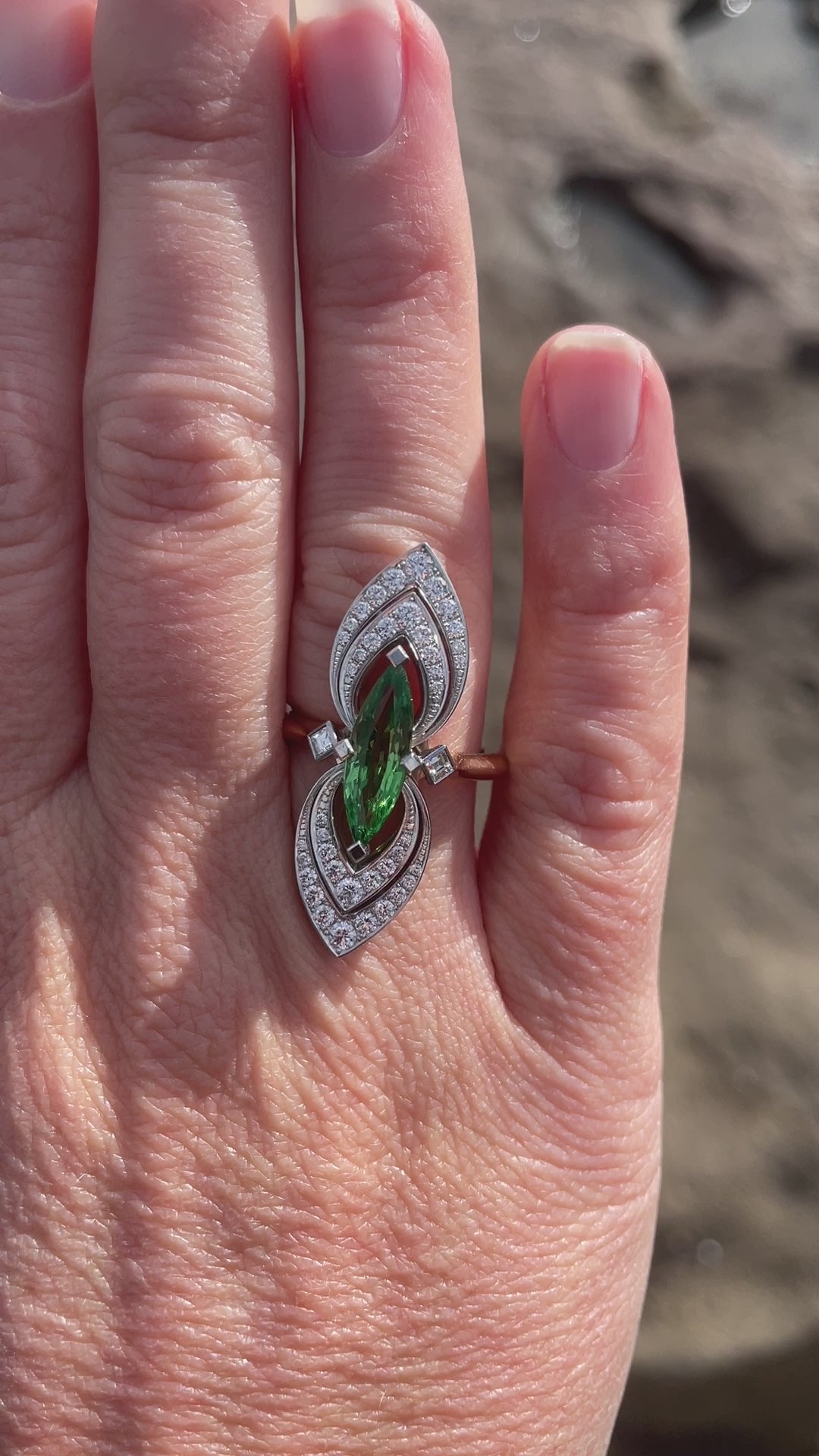 Wearing bespoke platinum and rose gold ring with a 2.25ct marquise tsavorite garnet and round brilliant and carre cut diamonds. Handmade by Sydney jeweller Nicky Burles.