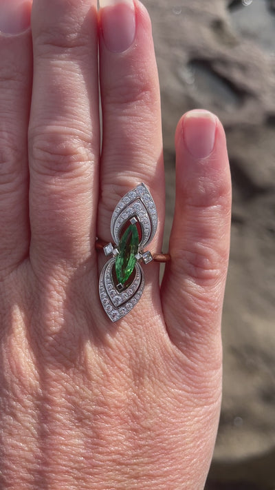 Wearing bespoke platinum and rose gold ring with a 2.25ct marquise tsavorite garnet and round brilliant and carre cut diamonds. Handmade by Sydney jeweller Nicky Burles.